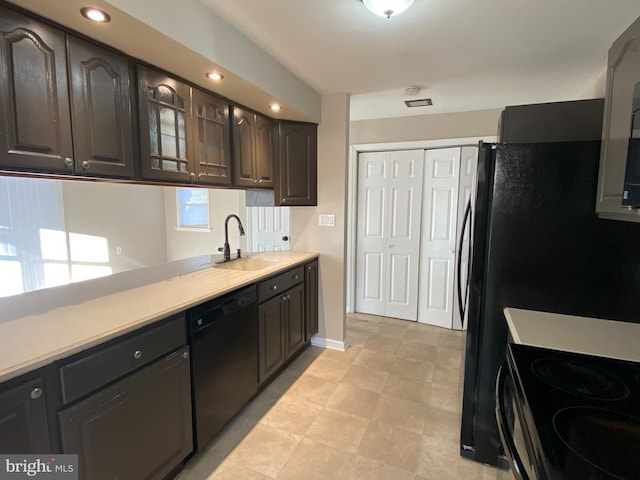 kitchen with dark brown cabinets, sink, and black appliances