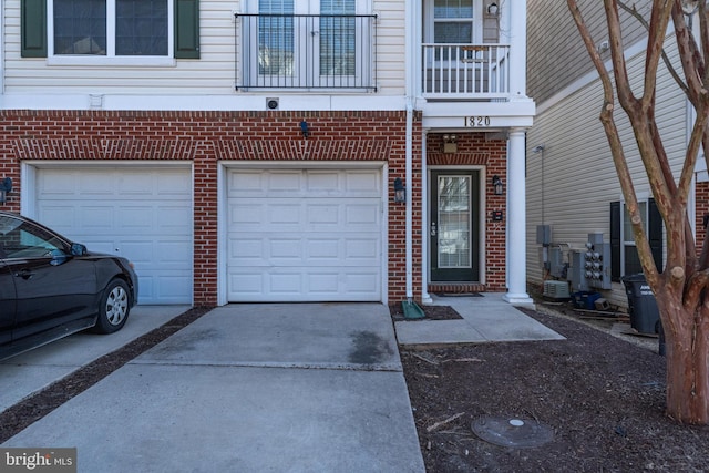 garage featuring concrete driveway