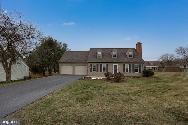 new england style home with a garage and a front lawn