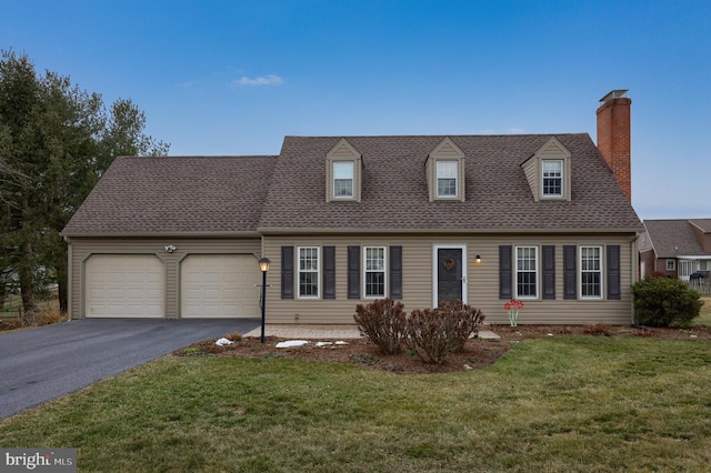 new england style home featuring a garage and a front lawn