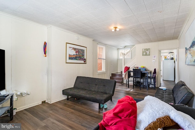 living room featuring dark wood finished floors and stairway