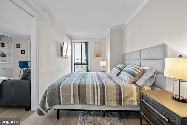 bedroom with ornamental molding and wood-type flooring