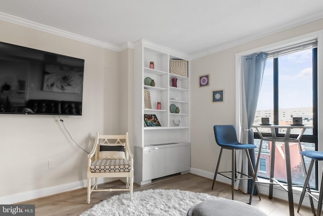 sitting room featuring hardwood / wood-style flooring and crown molding