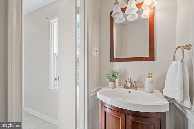 bathroom with vanity and a notable chandelier