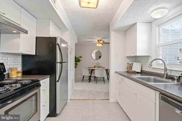 kitchen with sink, ceiling fan, white cabinets, and appliances with stainless steel finishes