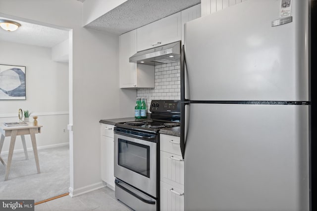 kitchen featuring extractor fan, appliances with stainless steel finishes, white cabinets, decorative backsplash, and a textured ceiling