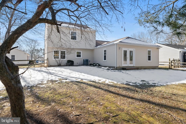 back of property with central AC unit and french doors