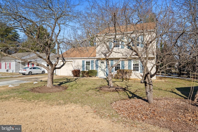 view of front of house with a garage and a front yard