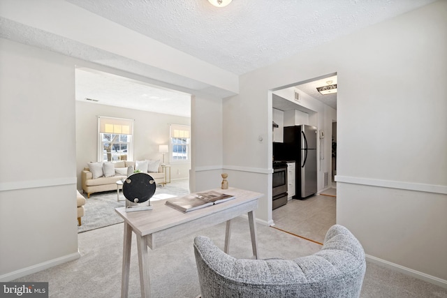 office with light carpet and a textured ceiling