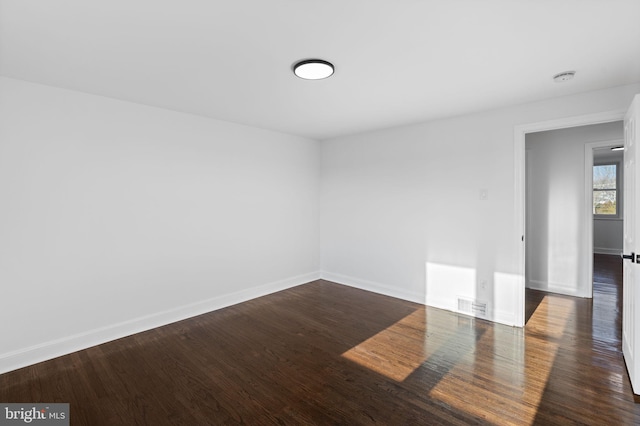 empty room featuring dark hardwood / wood-style floors