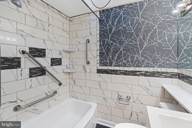 bathroom with tiled shower / bath, tile walls, and toilet