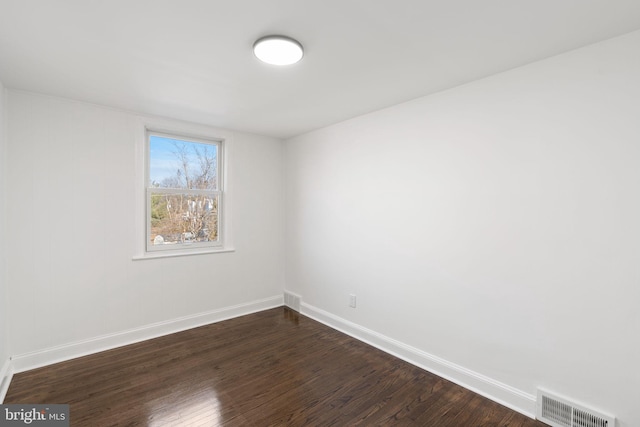 empty room featuring dark wood-type flooring