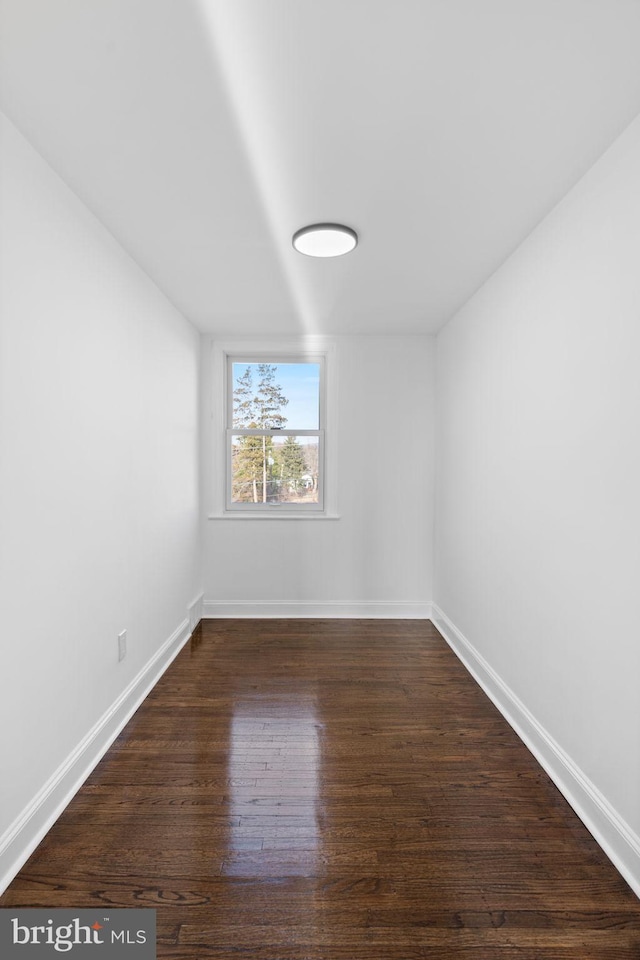 spare room featuring dark hardwood / wood-style flooring