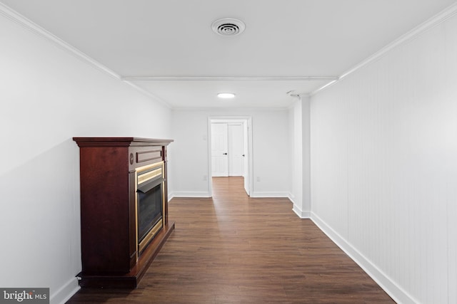 corridor with crown molding and dark hardwood / wood-style flooring