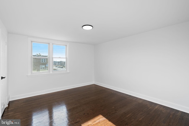 spare room featuring dark hardwood / wood-style floors