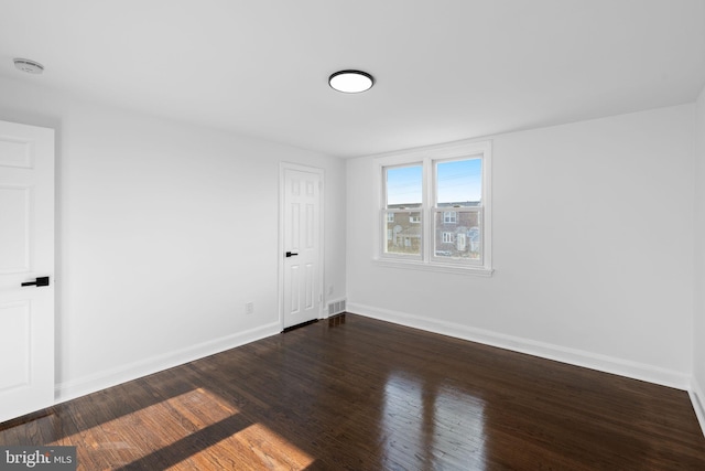 unfurnished room with dark hardwood / wood-style floors