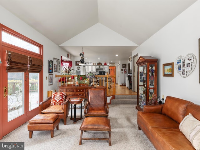 living room with carpet and vaulted ceiling