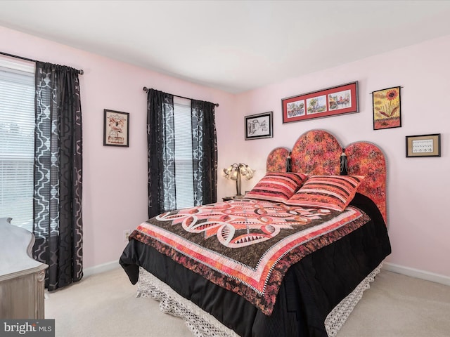 bedroom with carpet and baseboards