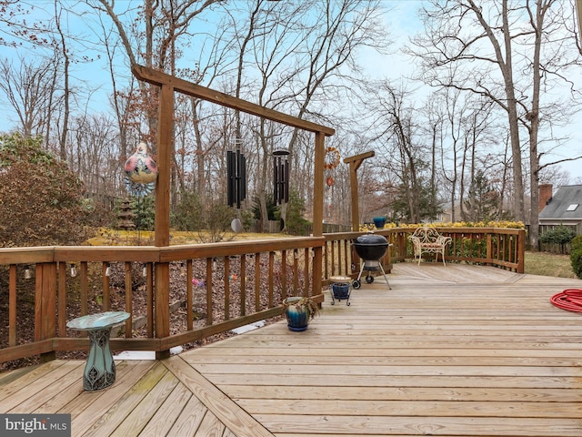 wooden deck with a grill