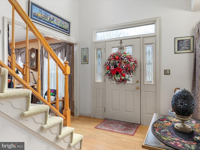 entrance foyer with light wood-style flooring and stairs