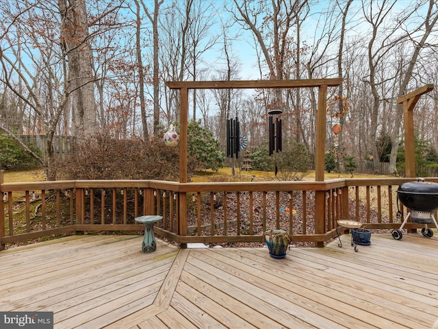 wooden terrace with fence and grilling area