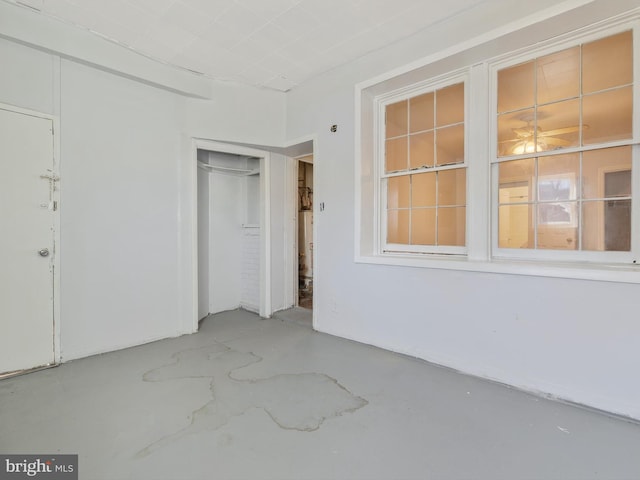 unfurnished bedroom featuring concrete floors and a closet