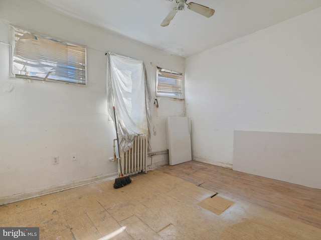 spare room featuring ceiling fan and radiator