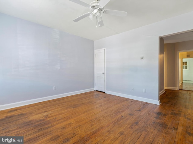 spare room featuring ceiling fan and dark hardwood / wood-style flooring