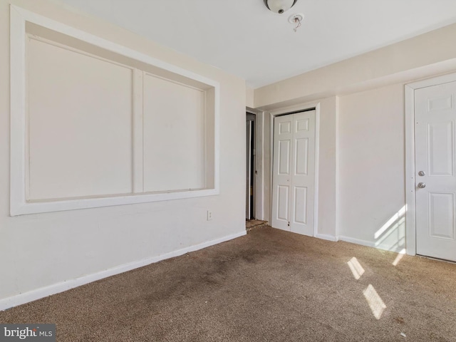 unfurnished bedroom featuring a closet and carpet