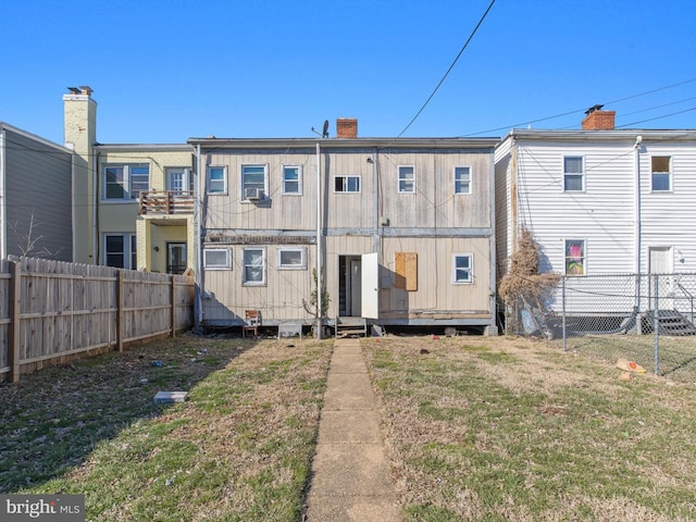 back of property featuring a lawn