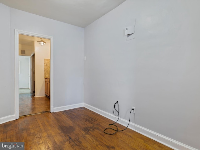 unfurnished room featuring dark hardwood / wood-style flooring