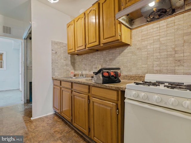 kitchen featuring sink, extractor fan, white gas stove, and decorative backsplash