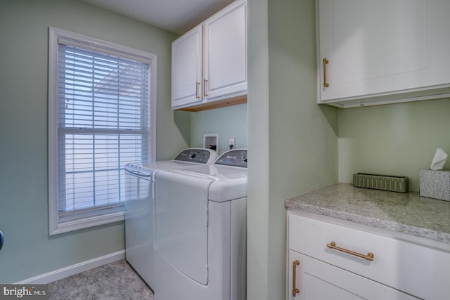 washroom featuring cabinets and washing machine and dryer