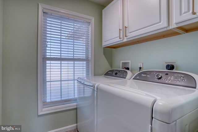 washroom featuring cabinets and washing machine and clothes dryer