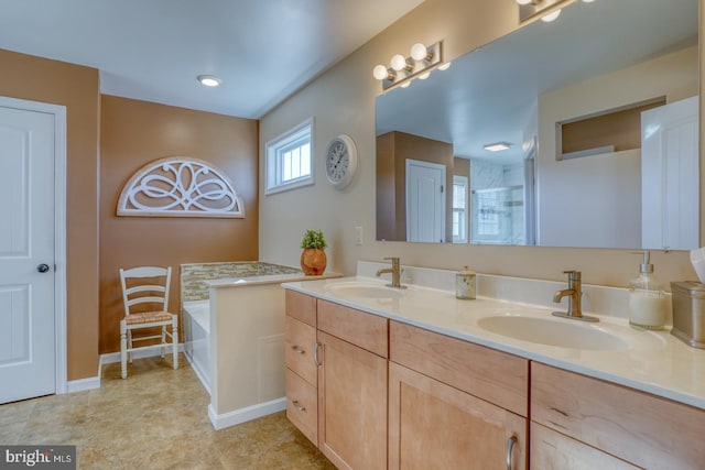 bathroom featuring a tub to relax in and vanity