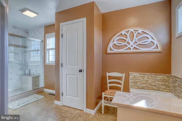 bathroom with decorative backsplash and a shower with shower door