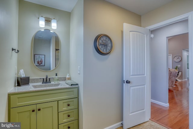 bathroom with hardwood / wood-style flooring and vanity