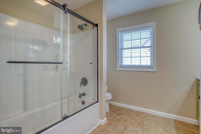 full bathroom with enclosed tub / shower combo, vanity, and toilet