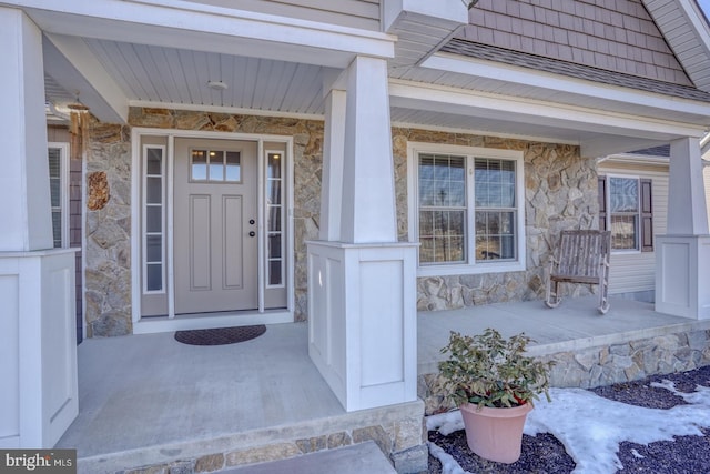 view of exterior entry featuring a porch