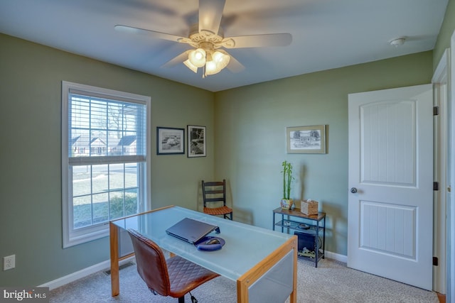 carpeted office space featuring ceiling fan