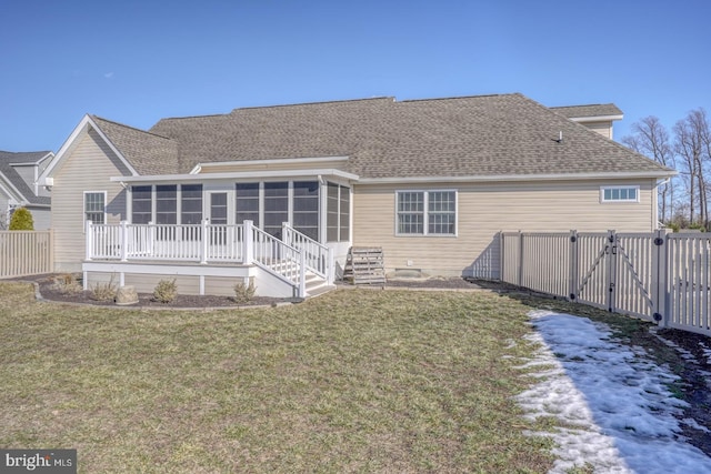 back of house with a yard and a sunroom