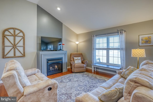 living room featuring hardwood / wood-style floors and high vaulted ceiling