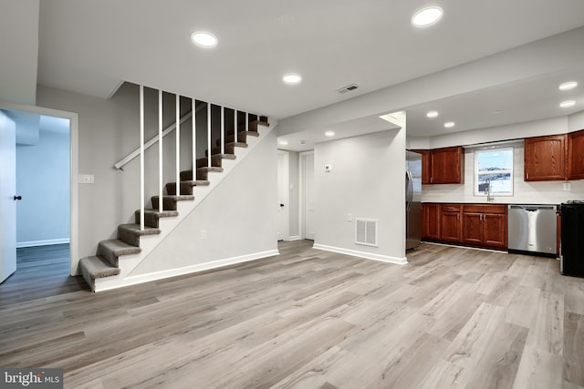 interior space with appliances with stainless steel finishes, light wood-style flooring, and visible vents