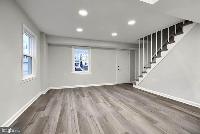 entrance foyer featuring baseboards, stairway, wood finished floors, and recessed lighting