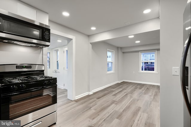 kitchen with white cabinetry, light wood-style flooring, appliances with stainless steel finishes, and recessed lighting