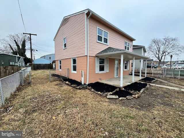 rear view of property with a patio area and a fenced backyard