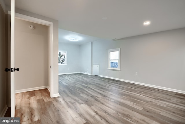 interior space featuring a healthy amount of sunlight, baseboards, and wood finished floors