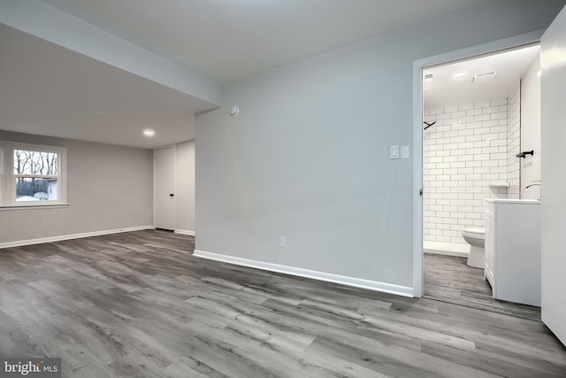 interior space with baseboards and wood finished floors