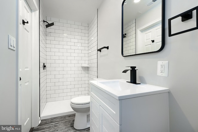 bathroom with toilet, a shower stall, visible vents, and vanity