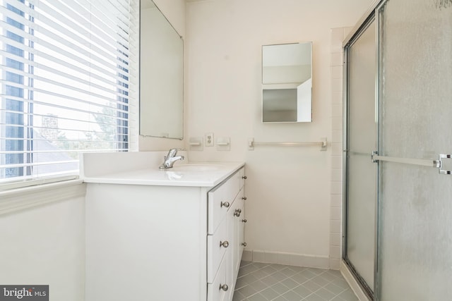 bathroom featuring an enclosed shower, vanity, and tile patterned flooring